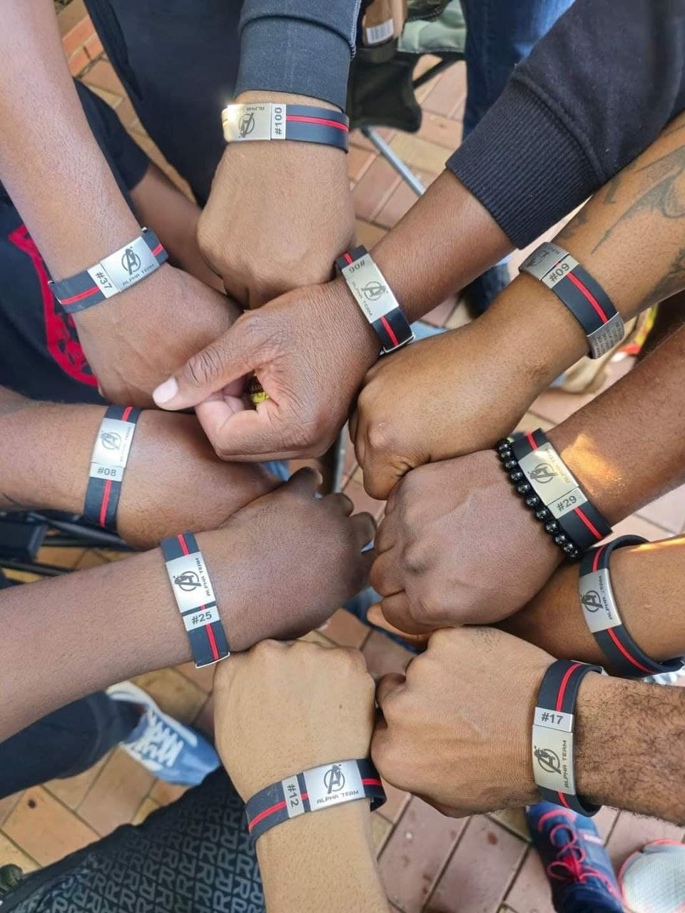 Alpha Team riders showing their ICE wristbands with ride numbers